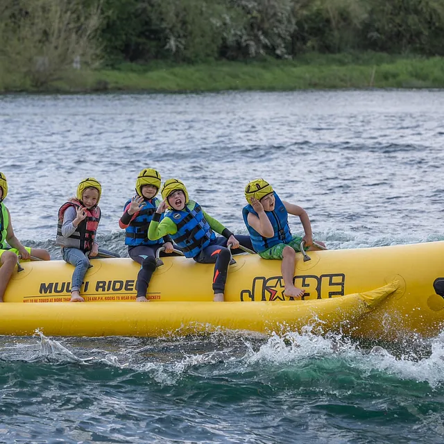 children having fun on a banana inflatable ride